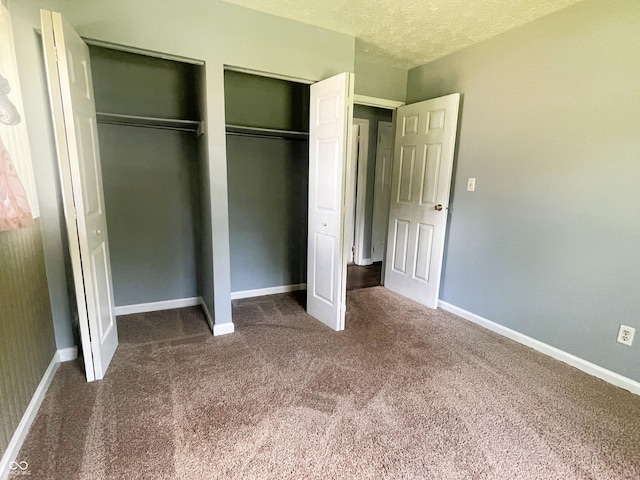 3911 Eastwind St, Indianapolis, IN 46237 - unfurnished bedroom featuring carpet floors, multiple closets, and a textured ceiling
