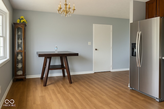 3911 Eastwind St, Indianapolis, IN 46237 - unfurnished dining area with light wood-type flooring and a chandelier