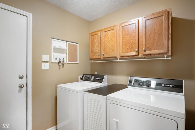 8365 Captain Dr, Avon, IN 46123 - laundry area with independent washer and dryer, cabinet space, and a textured ceiling