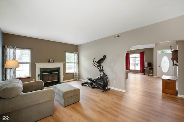 8365 Captain Dr, Avon, IN 46123 - living room with plenty of natural light, light wood-style floors, arched walkways, and a premium fireplace
