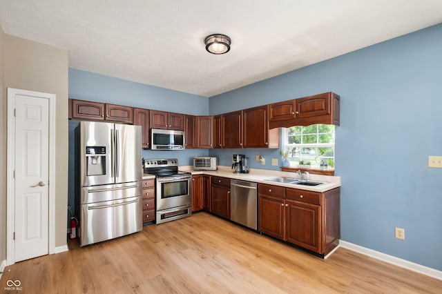 8365 Captain Dr, Avon, IN 46123 - kitchen with appliances with stainless steel finishes, light countertops, and light wood-style flooring