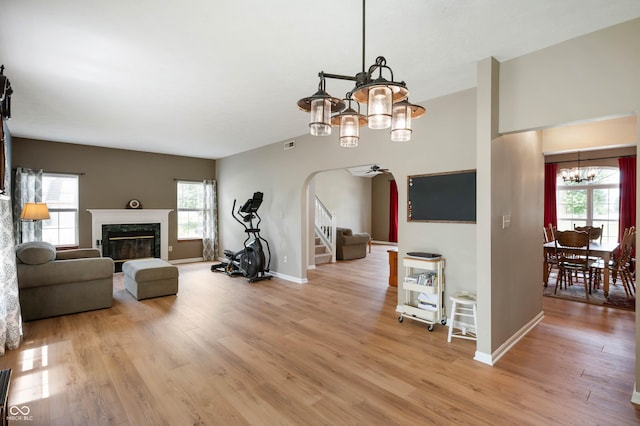 8365 Captain Dr, Avon, IN 46123 - living room with a chandelier, plenty of natural light, and arched walkways