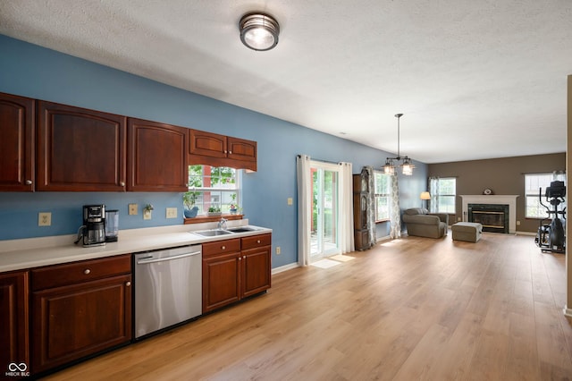 8365 Captain Dr, Avon, IN 46123 - kitchen with stainless steel dishwasher, plenty of natural light, light countertops, light wood finished floors, and a textured ceiling