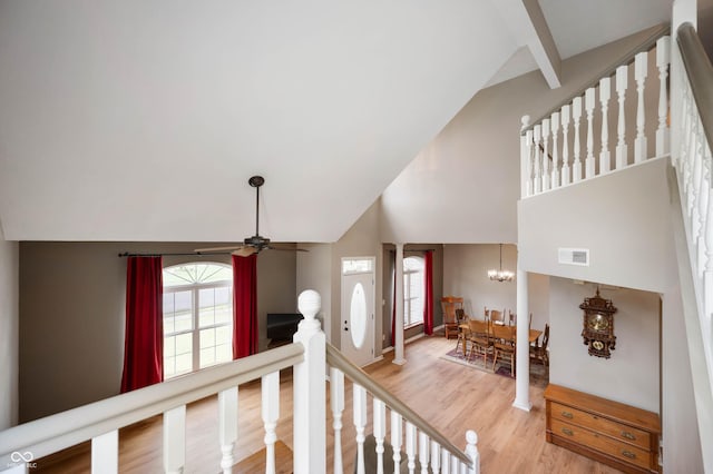 8365 Captain Dr, Avon, IN 46123 - staircase with high vaulted ceiling, a ceiling fan, wood finished floors, plenty of natural light, and a chandelier