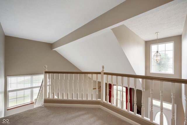 8365 Captain Dr, Avon, IN 46123 - corridor featuring carpet flooring, a chandelier, an upstairs landing, and vaulted ceiling