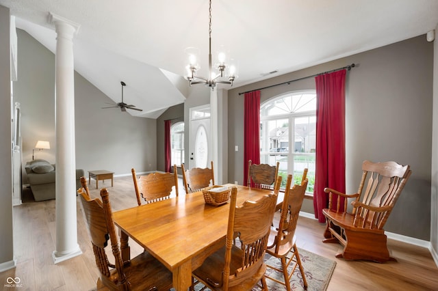 8365 Captain Dr, Avon, IN 46123 - dining area featuring decorative columns, ceiling fan, light wood-style flooring, lofted ceiling, and a chandelier