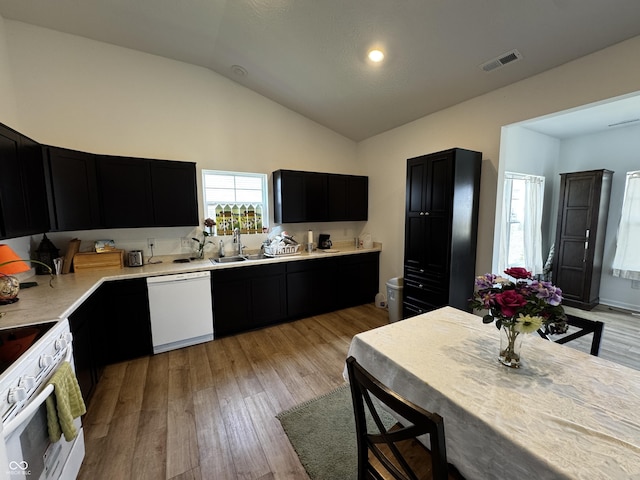 602 Tuscany Trl, Lapel, IN 46051 - kitchen with white appliances, dark cabinetry, light countertops, light wood-style flooring, and high vaulted ceiling