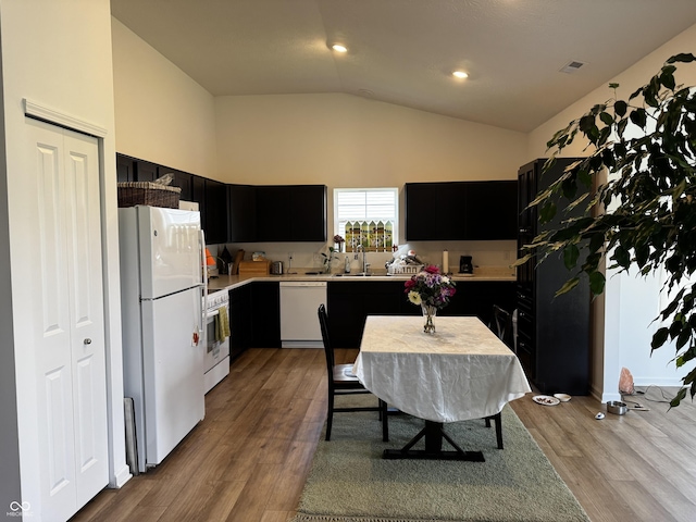 602 Tuscany Trl, Lapel, IN 46051 - kitchen featuring white appliances, dark cabinetry, light countertops, lofted ceiling, and wood finished floors