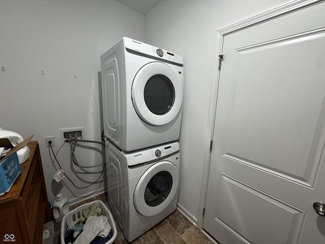 602 Tuscany Trl, Lapel, IN 46051 - washroom with stacked washing machine and dryer and dark stone finish floors