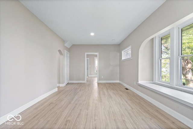 2813 S Monroe St, Muncie, IN 47302 - empty room featuring plenty of natural light, arched walkways, light wood finished floors, and recessed lighting