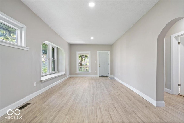 2813 S Monroe St, Muncie, IN 47302 - empty room featuring healthy amount of natural light, arched walkways, light wood-style flooring, and recessed lighting