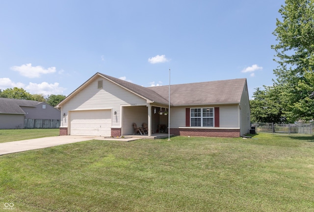 2082 Fiesbeck Dr, Columbus, IN 47201 - view of front of property with brick siding, an attached garage, driveway, and a shingled roof