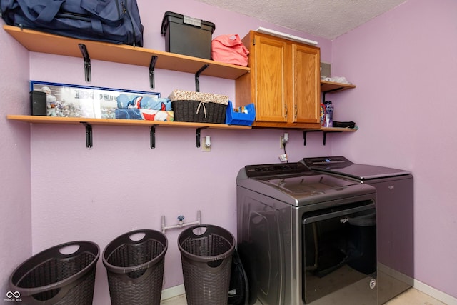 2082 Fiesbeck Dr, Columbus, IN 47201 - laundry area with cabinet space, washer and dryer, and a textured ceiling