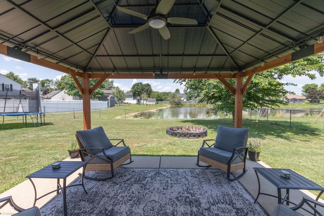 2082 Fiesbeck Dr, Columbus, IN 47201 - fenced backyard featuring a gazebo, a trampoline, a water view, and a fire pit