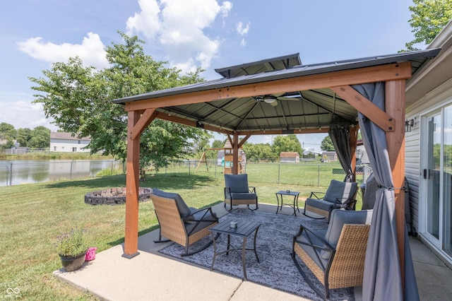 2082 Fiesbeck Dr, Columbus, IN 47201 - fenced backyard featuring a water view, a gazebo, a patio, and an outdoor living space with a fire pit