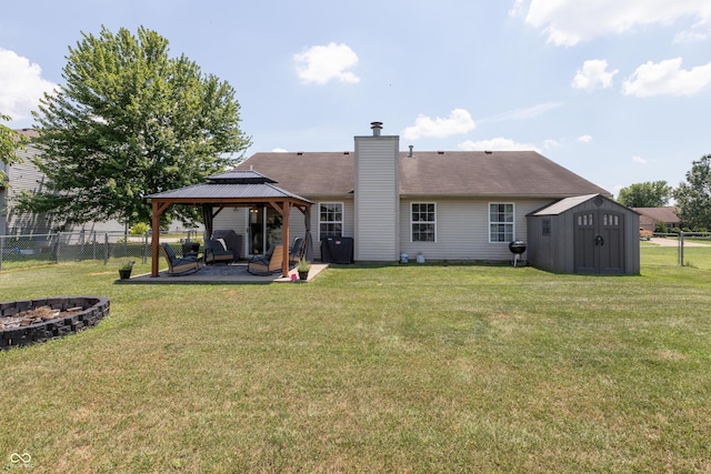 2082 Fiesbeck Dr, Columbus, IN 47201 - back of property with a gazebo, a fire pit, a shed, a patio, and a chimney