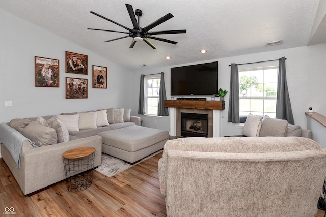 2082 Fiesbeck Dr, Columbus, IN 47201 - living room featuring light wood finished floors, ceiling fan, vaulted ceiling, recessed lighting, and a fireplace