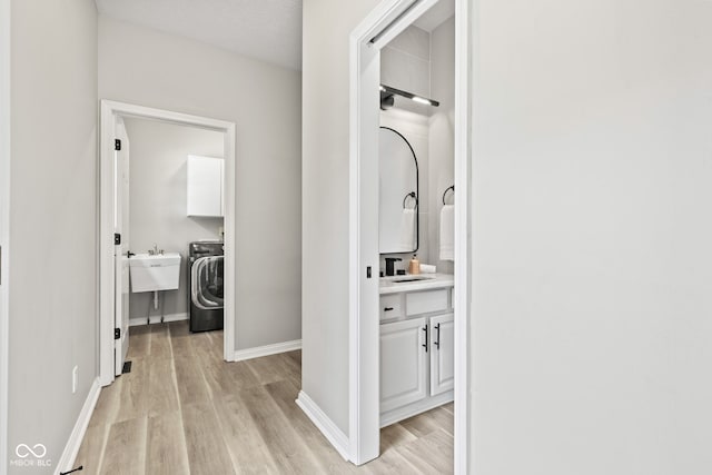 5910 Hickory Woods Dr, Plainfield, IN 46168 - hall featuring light wood-style floors and washer / dryer