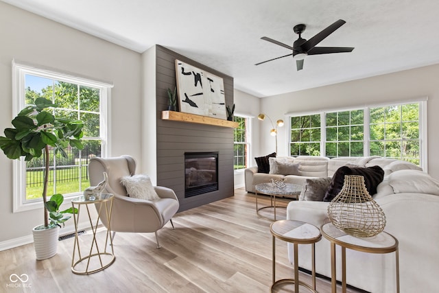 5910 Hickory Woods Dr, Plainfield, IN 46168 - living area with light wood-type flooring, a fireplace, and a ceiling fan