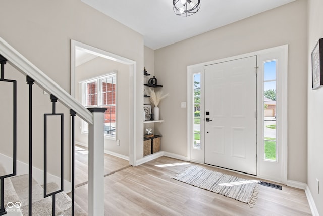 5910 Hickory Woods Dr, Plainfield, IN 46168 - entryway with light wood-type flooring, healthy amount of natural light, and stairs