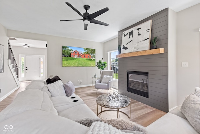 5910 Hickory Woods Dr, Plainfield, IN 46168 - living room featuring wood finished floors, a fireplace, and a ceiling fan