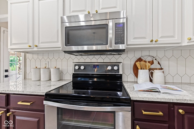5910 Hickory Woods Dr, Plainfield, IN 46168 - kitchen featuring stainless steel appliances, white cabinets, backsplash, and light stone countertops