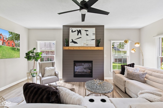 5910 Hickory Woods Dr, Plainfield, IN 46168 - living room with wood finished floors, a large fireplace, and a ceiling fan