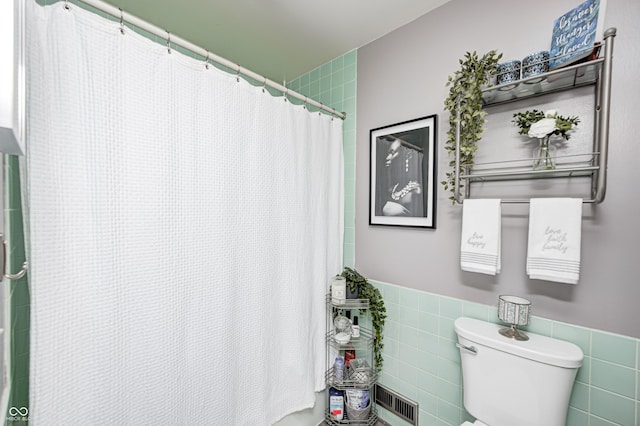 2206 Boston Ct Unit B, Indianapolis, IN 46228 - bathroom featuring tile walls, a shower with curtain, and wainscoting