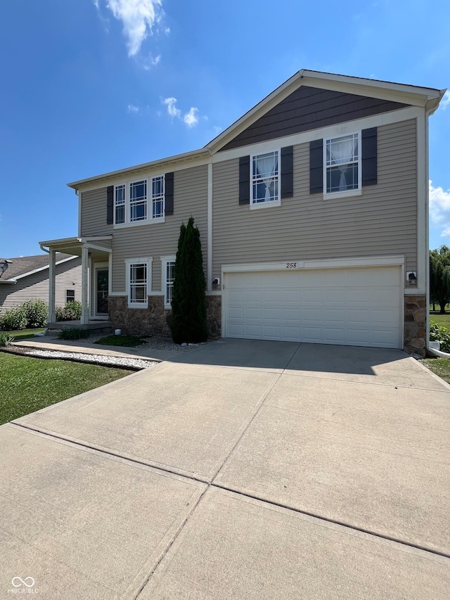 258 Center Ln, Crawfordsville, IN 47933 - view of front of house featuring stone siding, a garage, and driveway