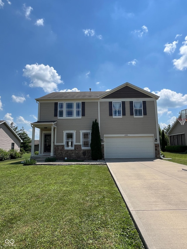 258 Center Ln, Crawfordsville, IN 47933 - view of front of house with an attached garage, driveway, stone siding, and a front yard