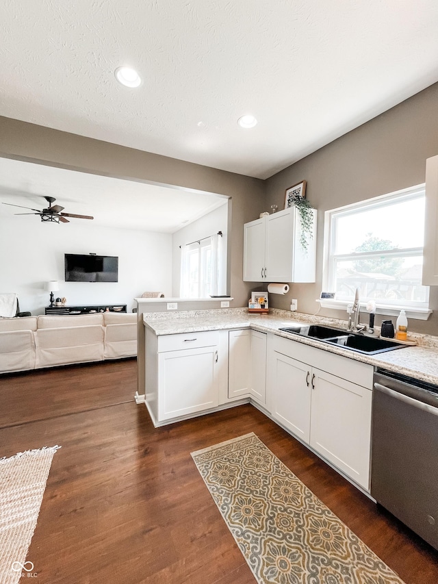 258 Center Ln, Crawfordsville, IN 47933 - kitchen with stainless steel dishwasher, a peninsula, white cabinets, a ceiling fan, and open floor plan