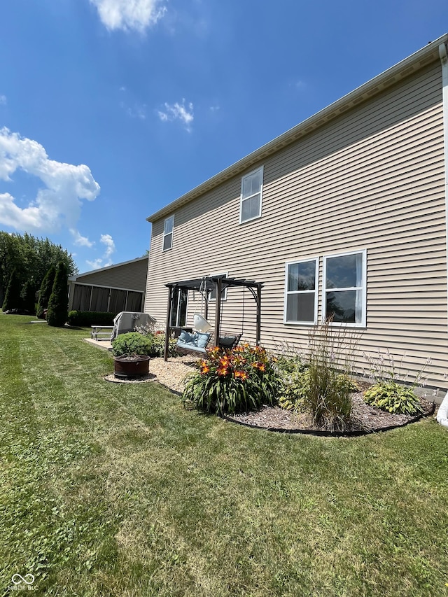 258 Center Ln, Crawfordsville, IN 47933 - rear view of house featuring a pergola and a lawn