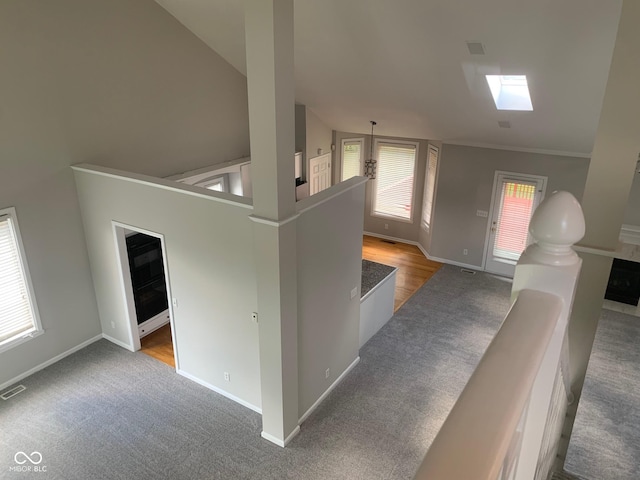 9532 Pinecreek Dr, Indianapolis, IN 46256 - corridor with a skylight, carpet flooring, an upstairs landing, and lofted ceiling