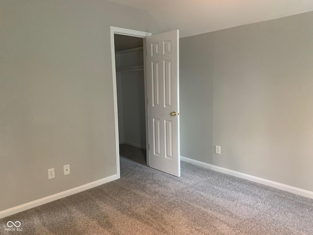 9532 Pinecreek Dr, Indianapolis, IN 46256 - unfurnished bedroom featuring carpet, a walk in closet, a closet, and lofted ceiling