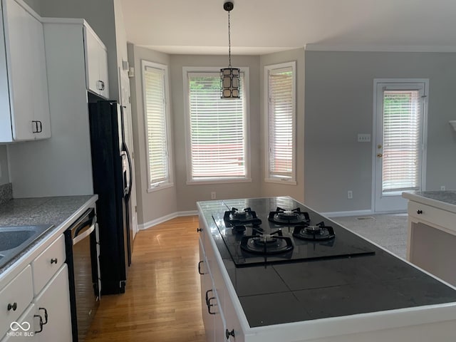 9532 Pinecreek Dr, Indianapolis, IN 46256 - kitchen featuring black appliances, light wood finished floors, white cabinetry, a center island, and decorative light fixtures