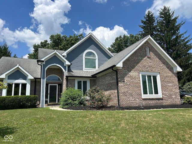 9532 Pinecreek Dr, Indianapolis, IN 46256 - view of front of house with a front lawn, brick siding, and a shingled roof