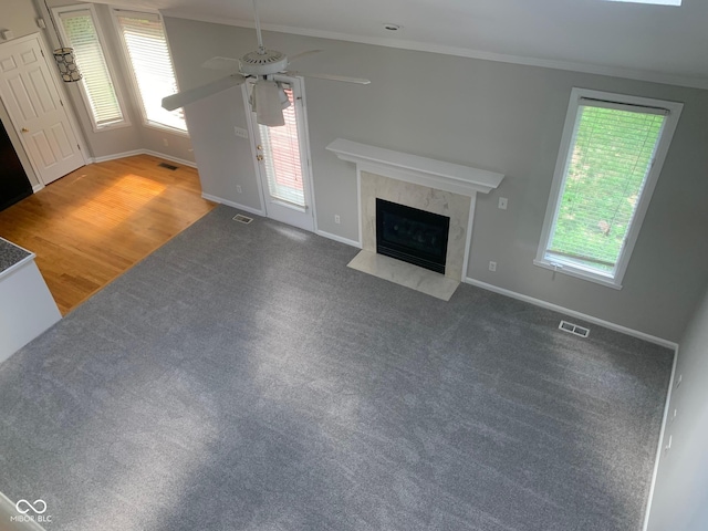 9532 Pinecreek Dr, Indianapolis, IN 46256 - unfurnished living room featuring ceiling fan, a high end fireplace, carpet flooring, and ornamental molding