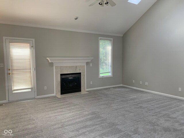 9532 Pinecreek Dr, Indianapolis, IN 46256 - unfurnished living room featuring ceiling fan, ornamental molding, a high end fireplace, carpet, and vaulted ceiling