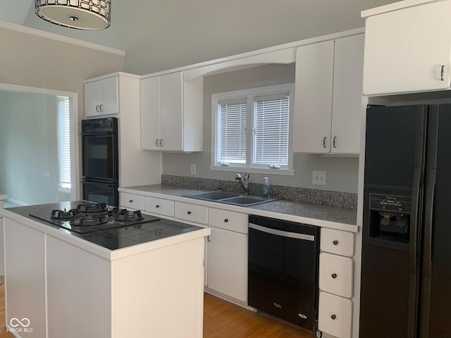 9532 Pinecreek Dr, Indianapolis, IN 46256 - kitchen featuring black appliances, white cabinetry, plenty of natural light, light wood-style floors, and crown molding