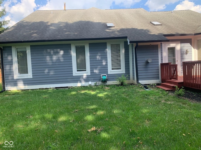 9532 Pinecreek Dr, Indianapolis, IN 46256 - rear view of house featuring roof with shingles, a deck, and a lawn