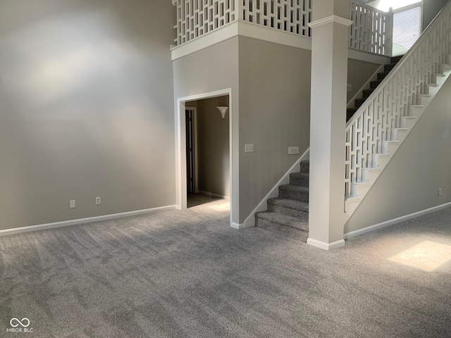 9532 Pinecreek Dr, Indianapolis, IN 46256 - stairway featuring a high ceiling and carpet