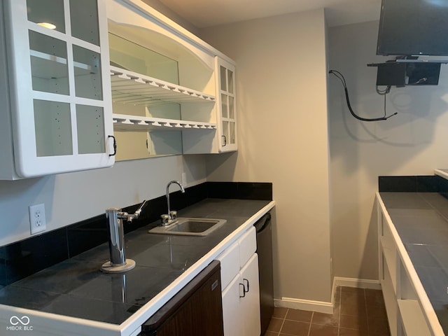 9532 Pinecreek Dr, Indianapolis, IN 46256 - kitchen with white cabinets, tile counters, dark tile patterned floors, dishwasher, and stainless steel dishwasher