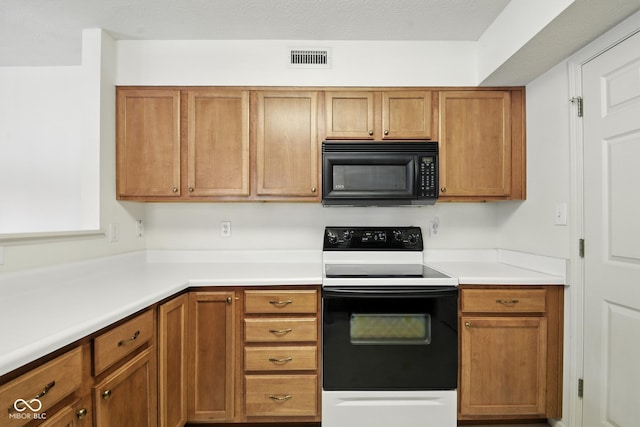 3096 Wildcat Ln, Indianapolis, IN 46203 - kitchen featuring black microwave, electric stove, brown cabinetry, and light countertops