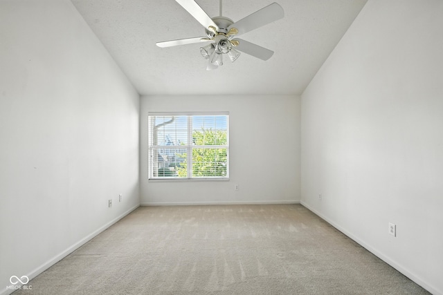 3096 Wildcat Ln, Indianapolis, IN 46203 - empty room featuring carpet flooring, ceiling fan, vaulted ceiling, and a textured ceiling