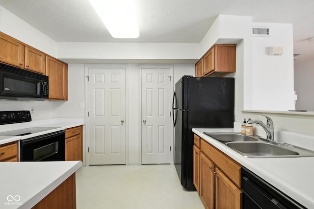 3096 Wildcat Ln, Indianapolis, IN 46203 - kitchen with black appliances, brown cabinetry, light countertops, and light floors