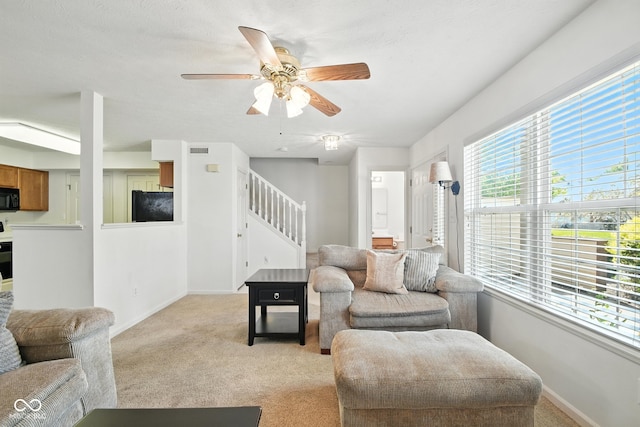 3096 Wildcat Ln, Indianapolis, IN 46203 - living area featuring light carpet, stairs, and healthy amount of natural light