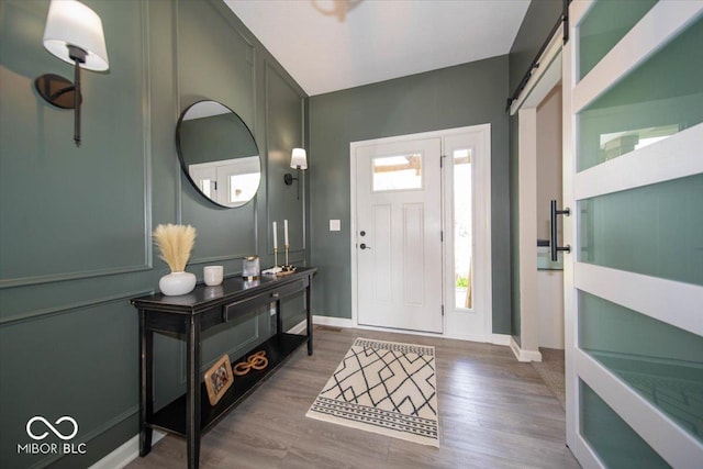 1615 N Blue Rd, Greenfield, IN 46140 - foyer featuring a barn door and wood finished floors