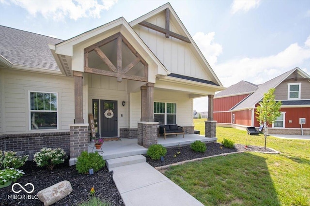 1615 N Blue Rd, Greenfield, IN 46140 - craftsman house with a porch, board and batten siding, a front lawn, brick siding, and a shingled roof