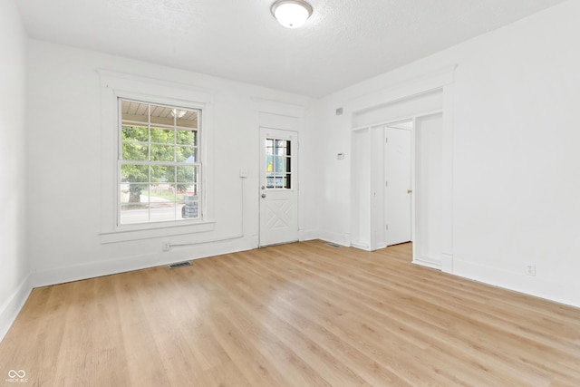 525 N Concord St N, Indianapolis, IN 46222 - empty room with light wood-style flooring and a textured ceiling