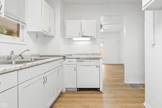 525 N Concord St N, Indianapolis, IN 46222 - kitchen with white dishwasher, ceiling fan, white cabinets, light countertops, and light wood finished floors